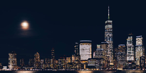 Amazing panorama view on New York City skyline and Downtown Manhattan from Jersey City during night, banner size