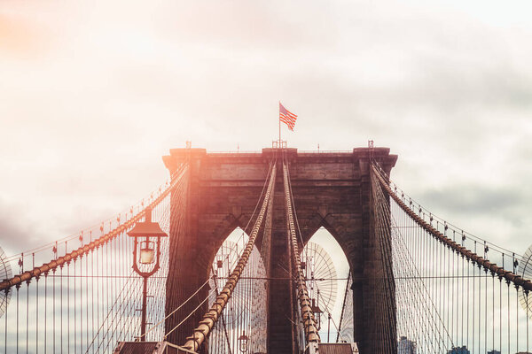 Details of the Brooklyn Bridge in New York City, USA. Toned image with sun light leak