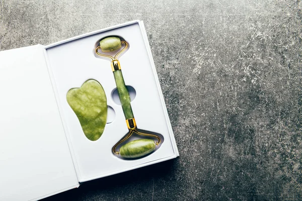 Jade face roller and Gua sha stone — Stock Photo, Image