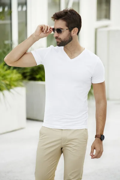 Handsome man adjusting sunglasses — Stock Photo, Image