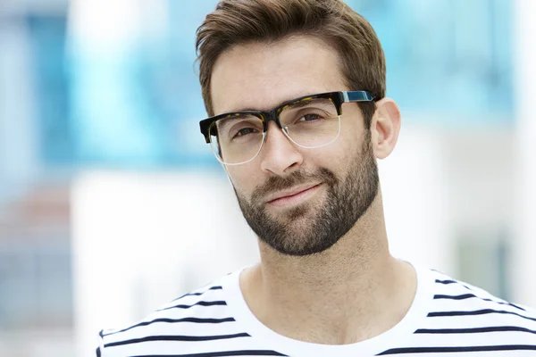 Man with stubble wearing spectacles