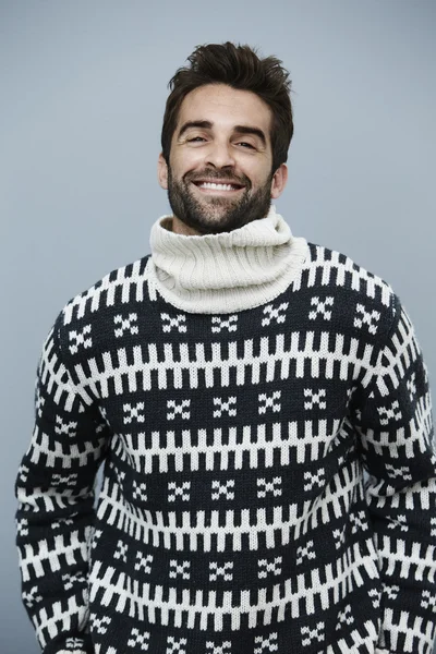 Handsome man in sweater laughing