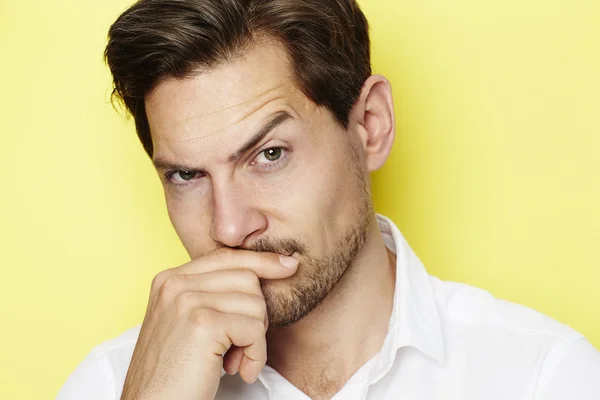 Quizzical man raising eyebrow — Stock Photo, Image