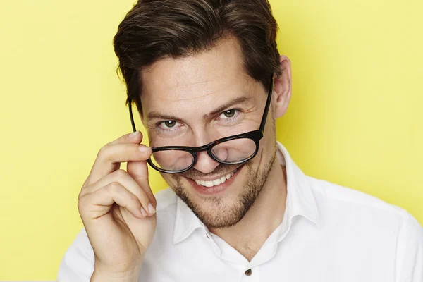 Man peering over spectacles — ストック写真