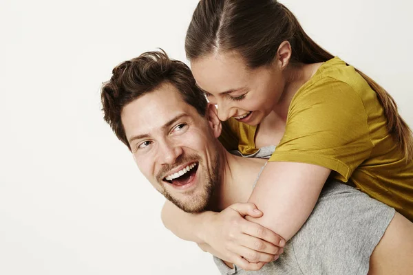 Laughing couple piggybacking — Stock Photo, Image