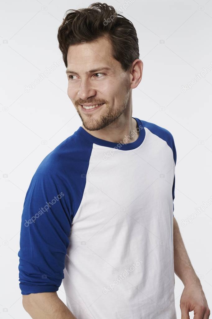 Smiling man in white and blue sweatshirt