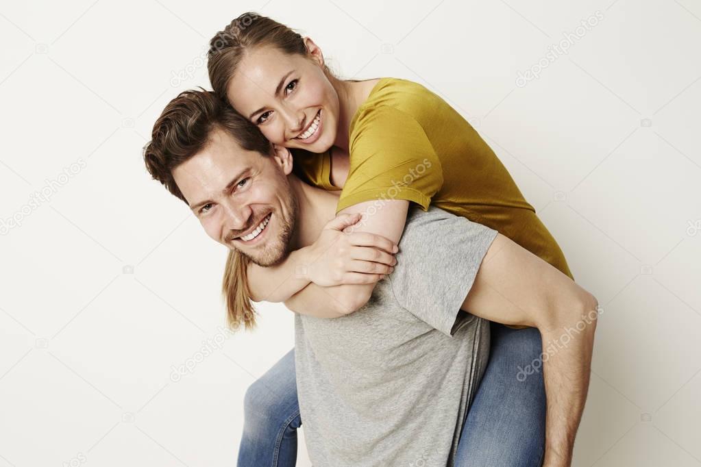 Laughing couple piggybacking