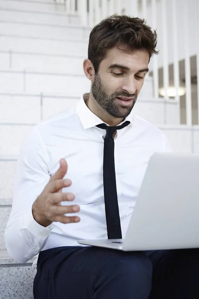 Businessman in shock looking at laptop — Stock Photo, Image