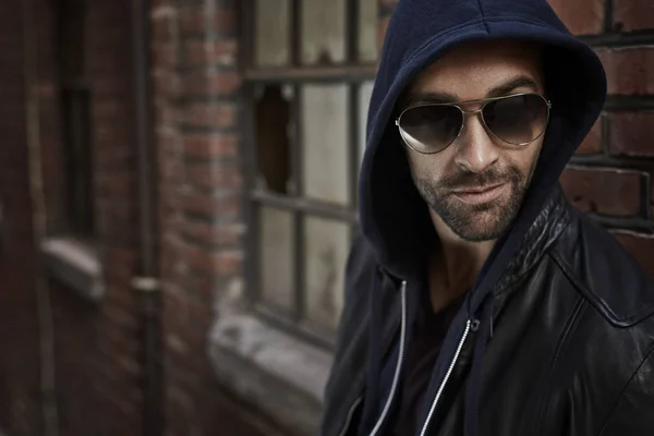 Handsome man in sunglasses and hood — Stock Photo, Image