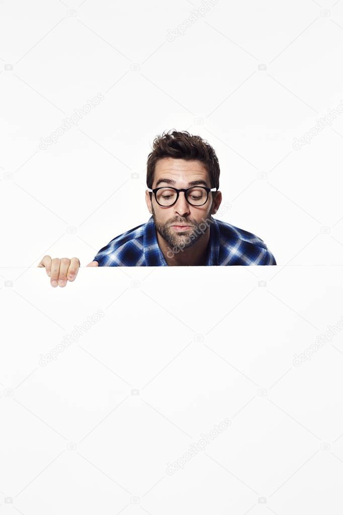 Man looking over white surface