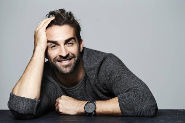 Gri süveterli gülümseyen adam