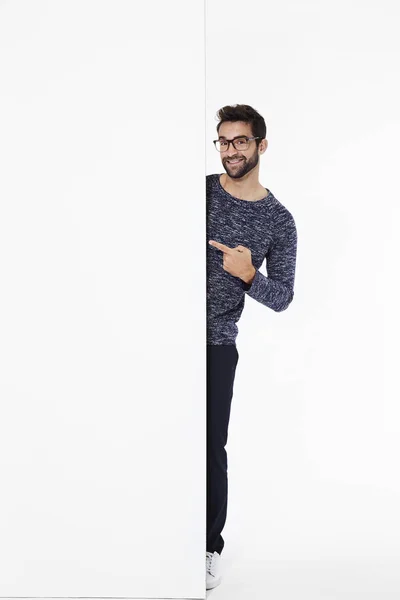 Handsome man in spectacles pointing — Stock Photo, Image