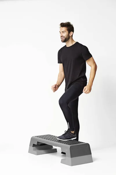 Man stepping on exercise step — Stock Photo, Image