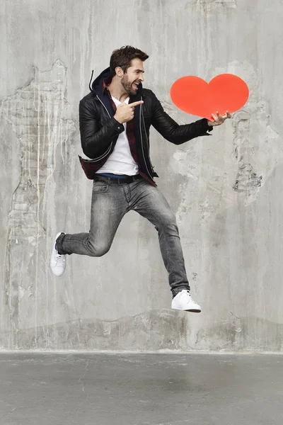 Man holding red heart