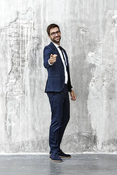 Man in suit pointing