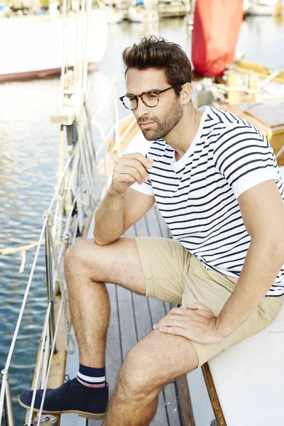 Bearded man on boat in harbor — Stock Photo, Image