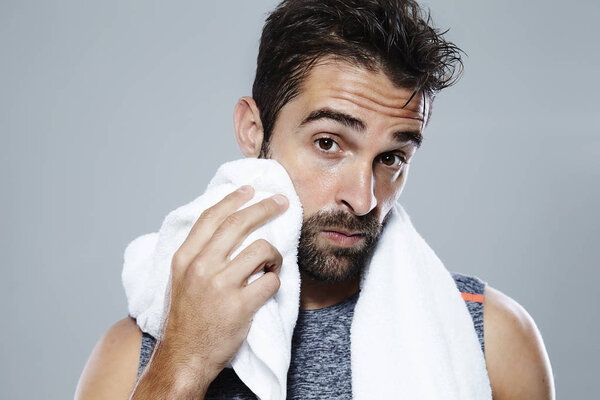 Sweating guy using towel