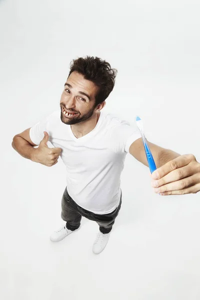 Gap toothed man with toothbrush — Stock Photo, Image