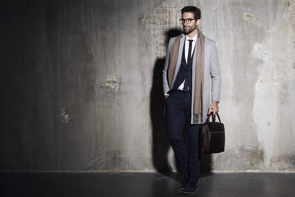 Businessman standing with briefcase   