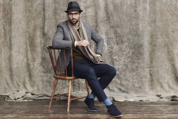 Hipster posing on chair