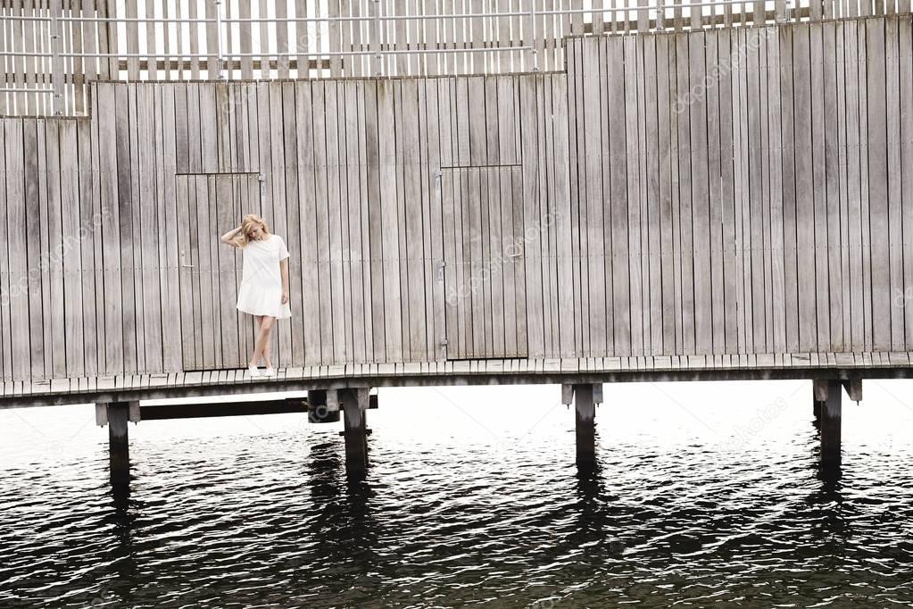Woman standing on wooden pier  