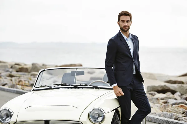 Stylish man in suit with car