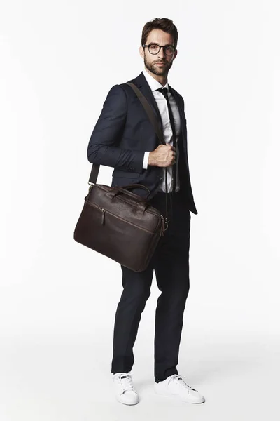 Serious businessman with bag — Stock Photo, Image