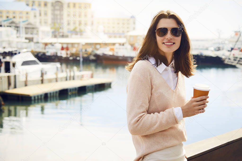 Woman in sunglasses at harbor