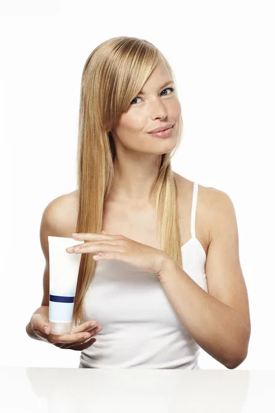 Woman holding beauty product — Stock Photo, Image