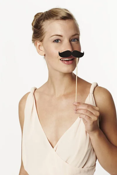 Woman holding joke mustache — Stock Photo, Image