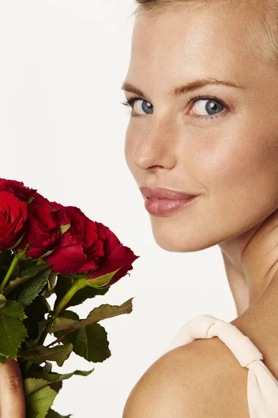 Beautiful woman with red roses — Stock Photo, Image