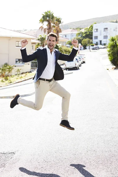 Man jumping for joy on street