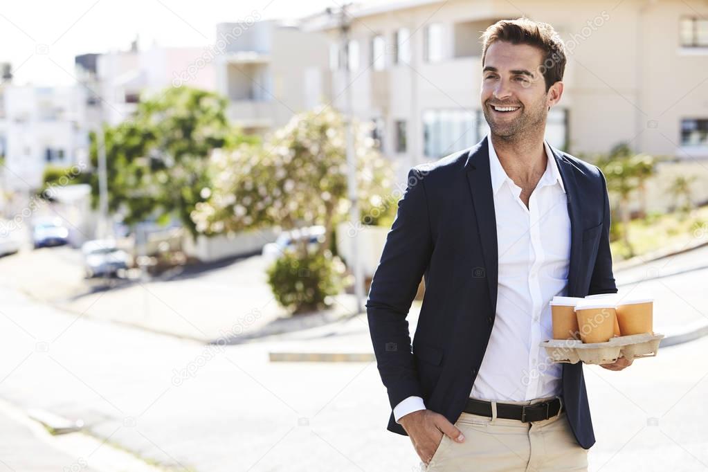 Smiling man with coffee cups