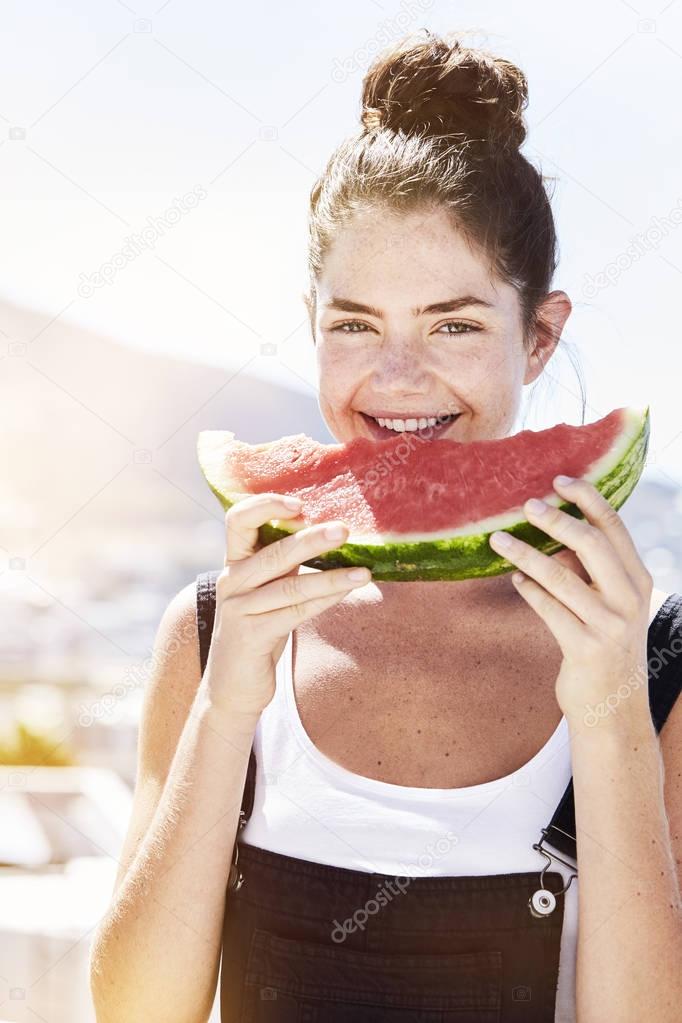 Brunette girl eating watermelon