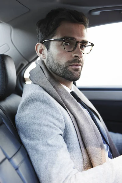Man in spectacles sitting in car — Stock Photo, Image