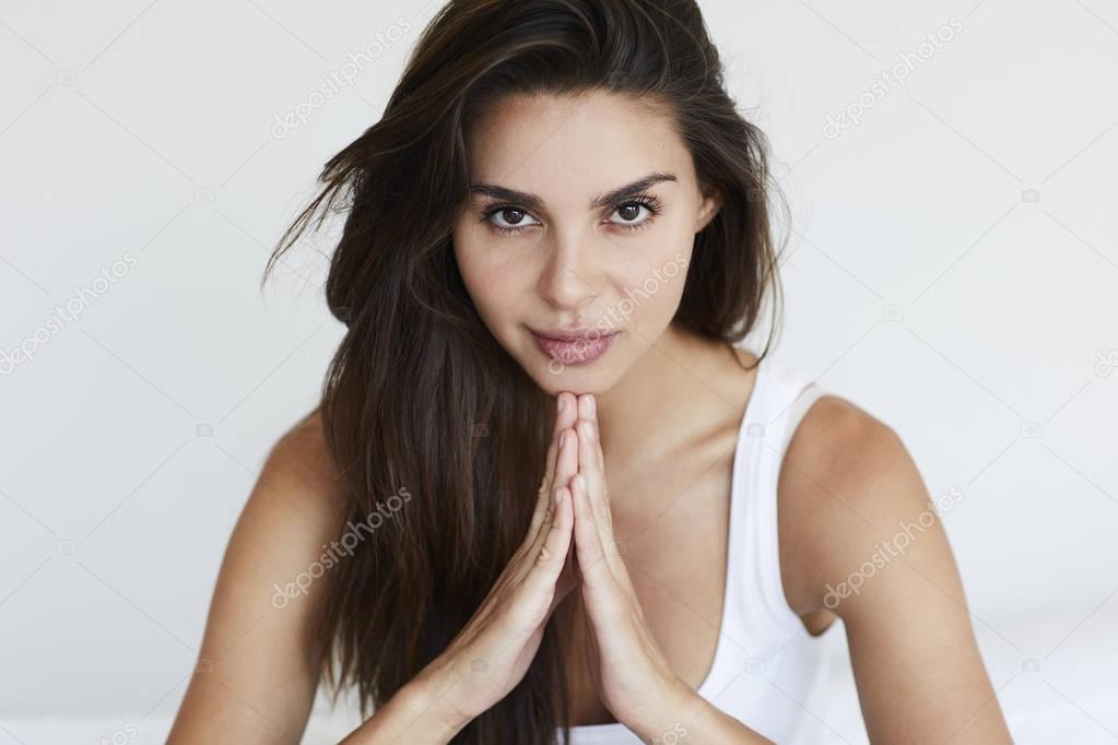 Brown eyed woman praying 