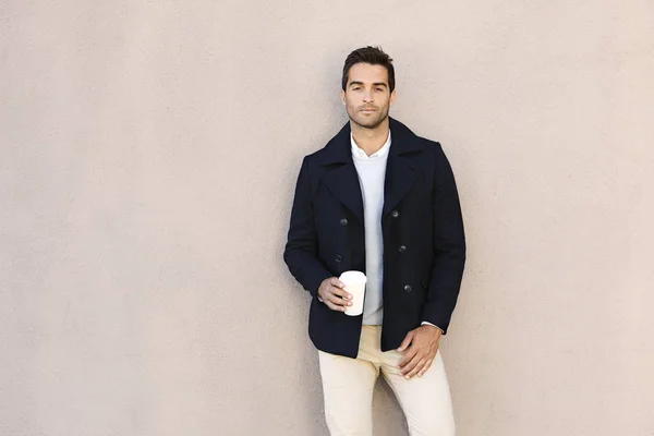 Young handsome man with cup of coffee — Stock Photo, Image