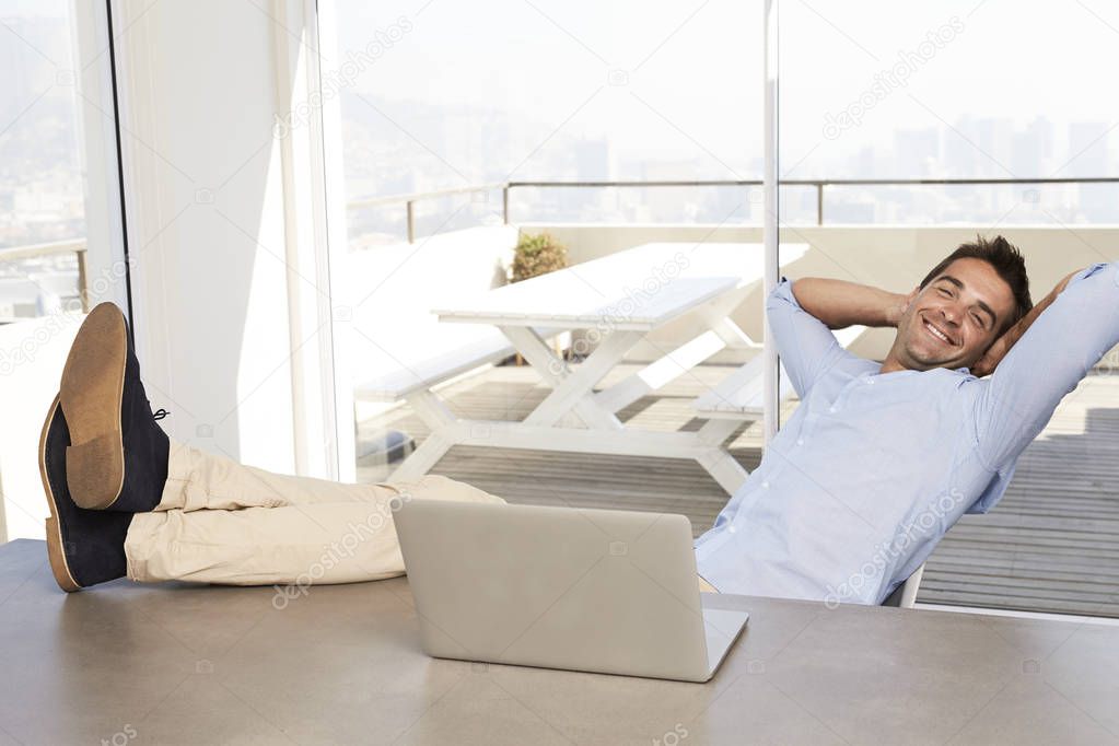Young man relaxing at table