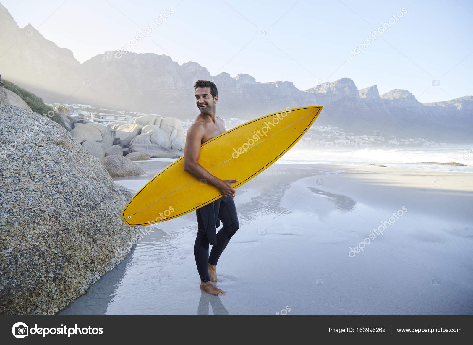 Guy on beach holding surfboard Stock Photo by sanneberg 163996262