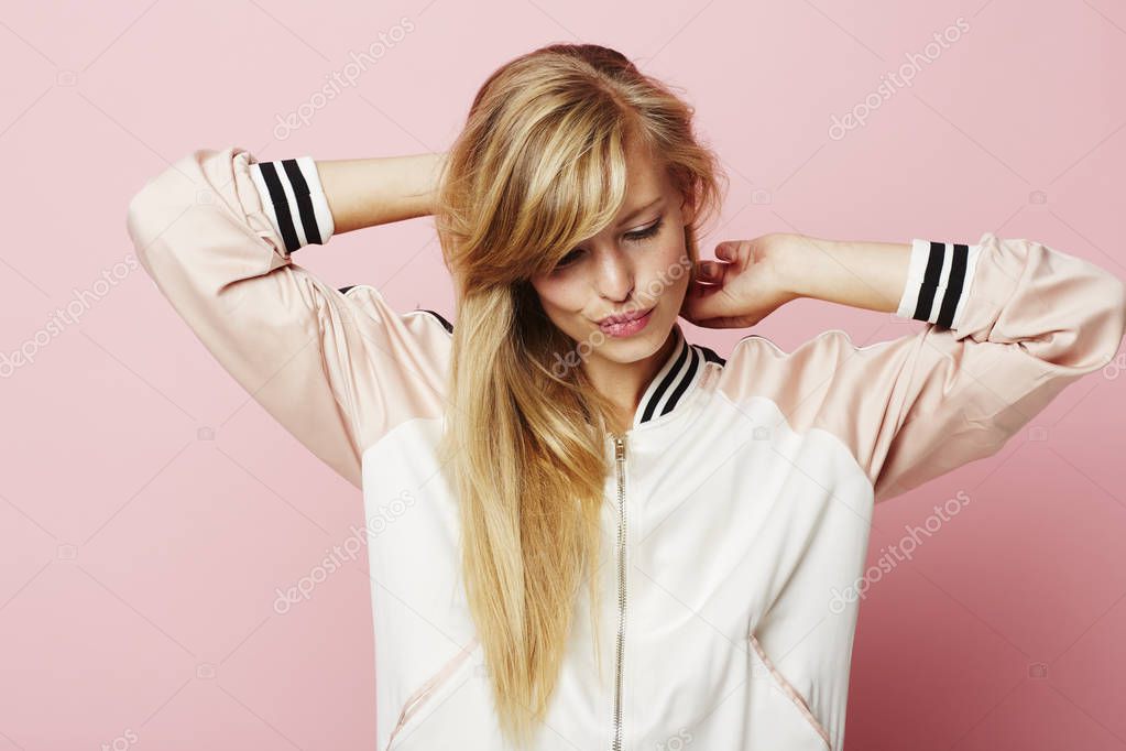 Beautiful blond woman setting hair 