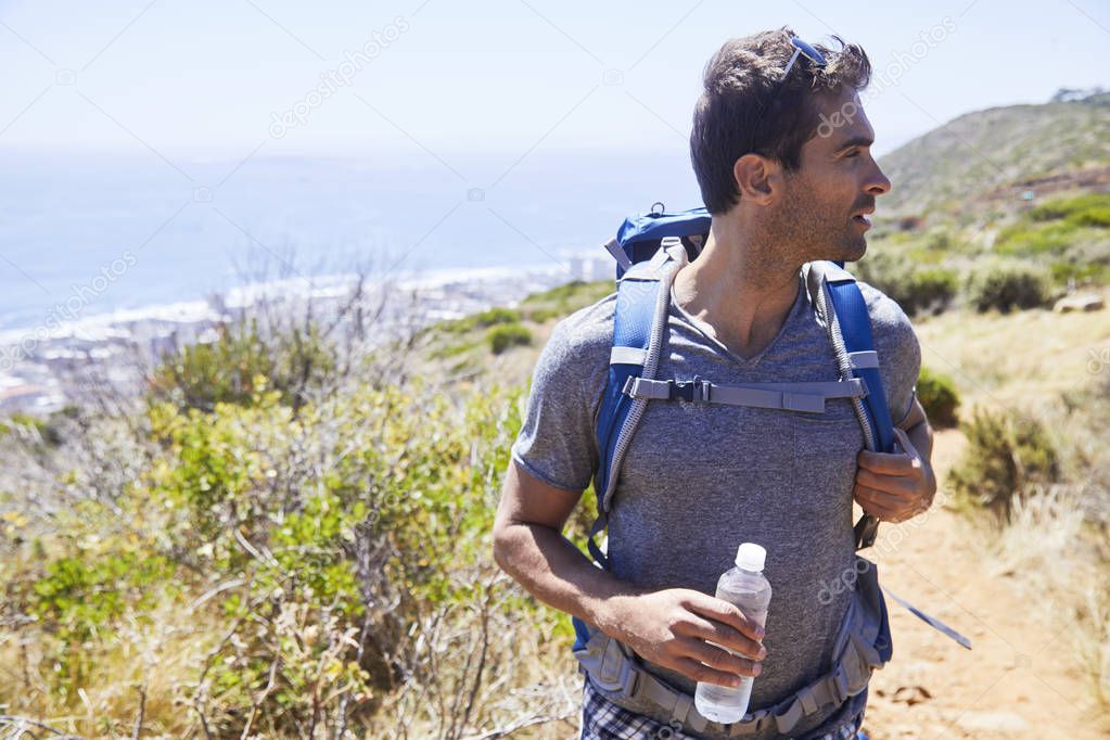 Handsome man with backpack hiking