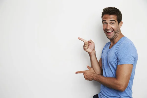 Guy pointing in studio — Stock Photo, Image