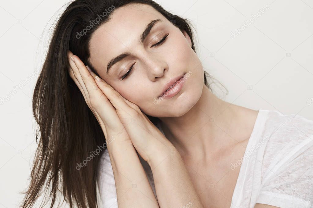 woman with closed eyes pretending to sleep