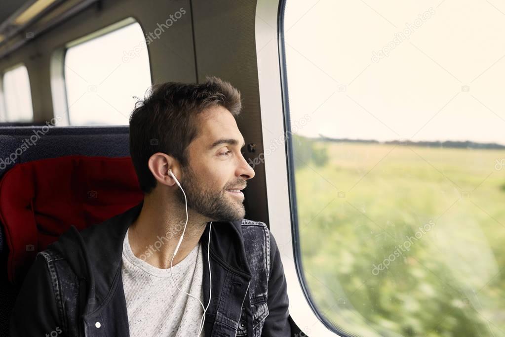 man on train listening to music