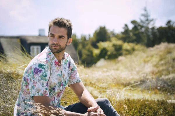 Handsome Guy sitting outdoors — Stock Photo, Image