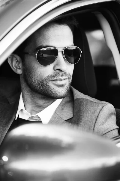 Handsome man sitting in car — Stock Photo, Image