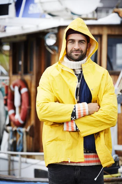 Handsome fisherman in waterproof jacket