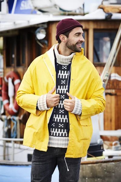 Handsome fisherman in waterproof jacket