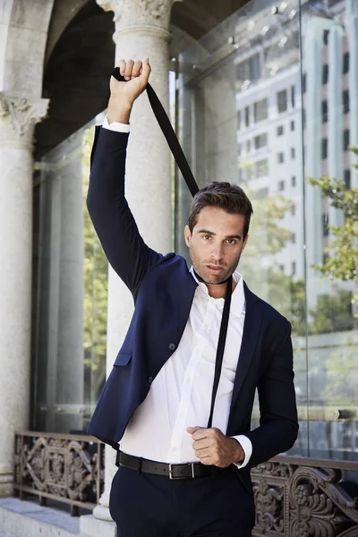 Businessman holding his tie — Stock Photo, Image