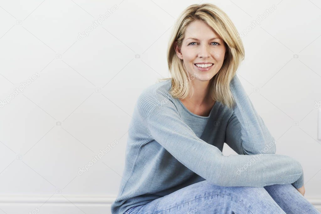 woman in jeans sitting on floor